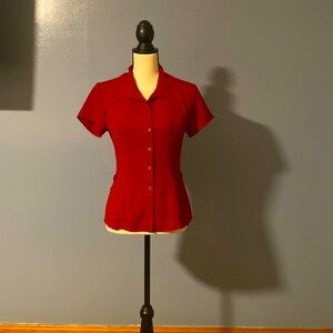 Mark Wong Nark , red blouse with snaps.